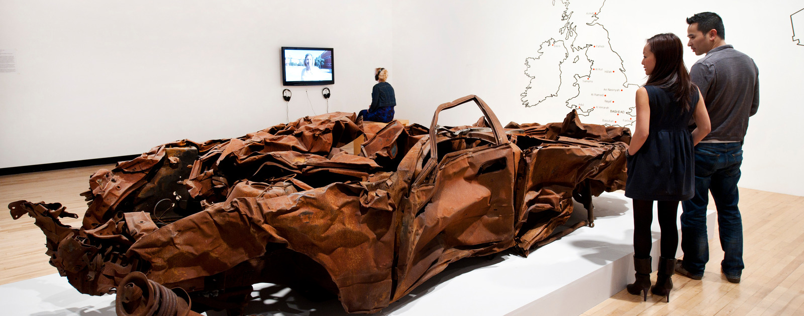 It Is What It Is by Jeremy Deller at Hayward Gallery 2012 Visitors Looking at Flattened Car by artist, Jeremy Deller at Hayward Gallery